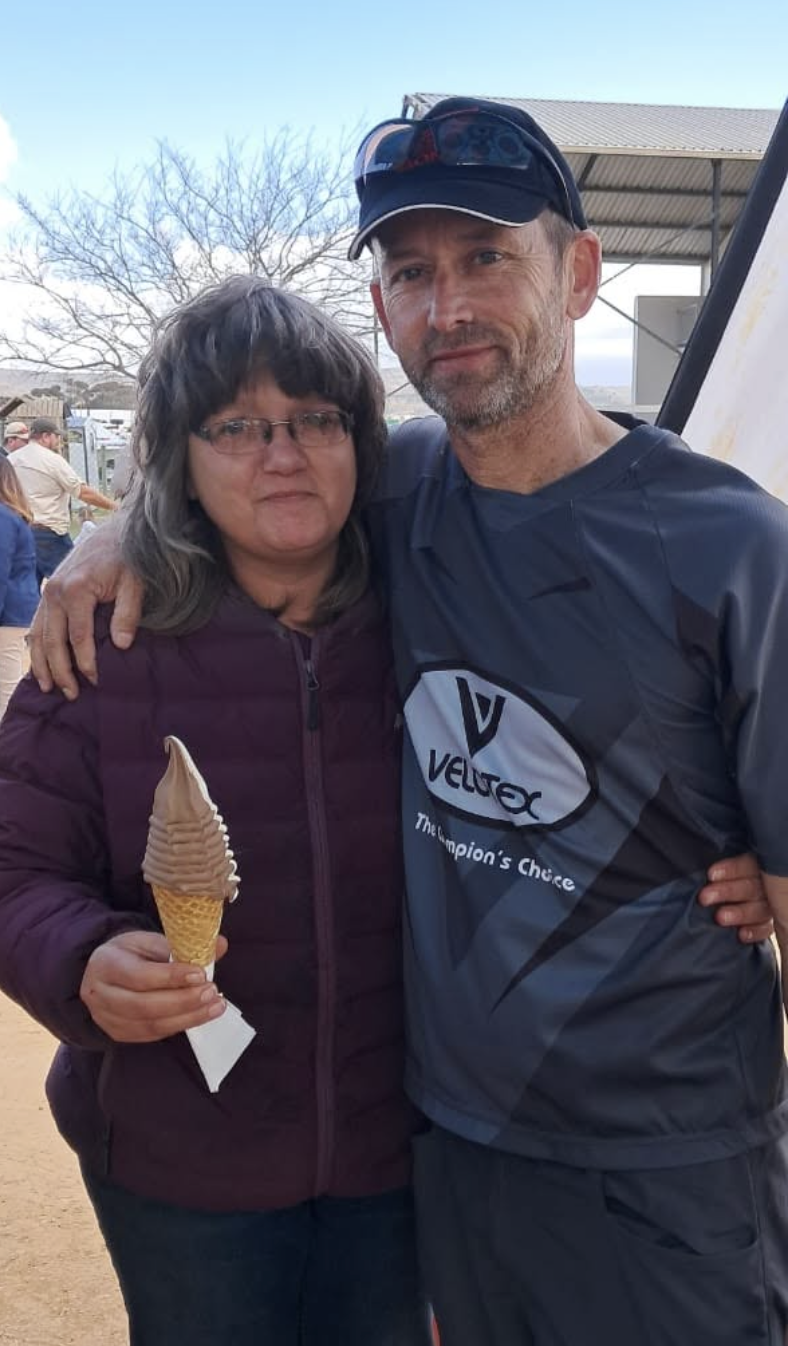 Wilma Maritz smiling with a soft serve cone alongside her partner at an event